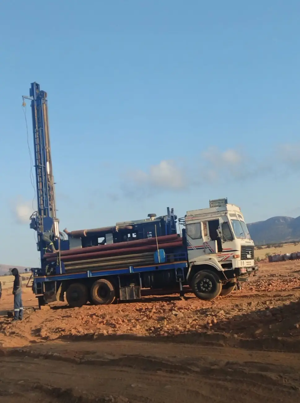 Borehole Drilling truck in a field